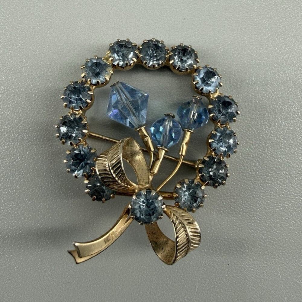 Vintage Unsigned Blue Rhinestone Floral Wreath Brooch Gold Tone Bow Pin